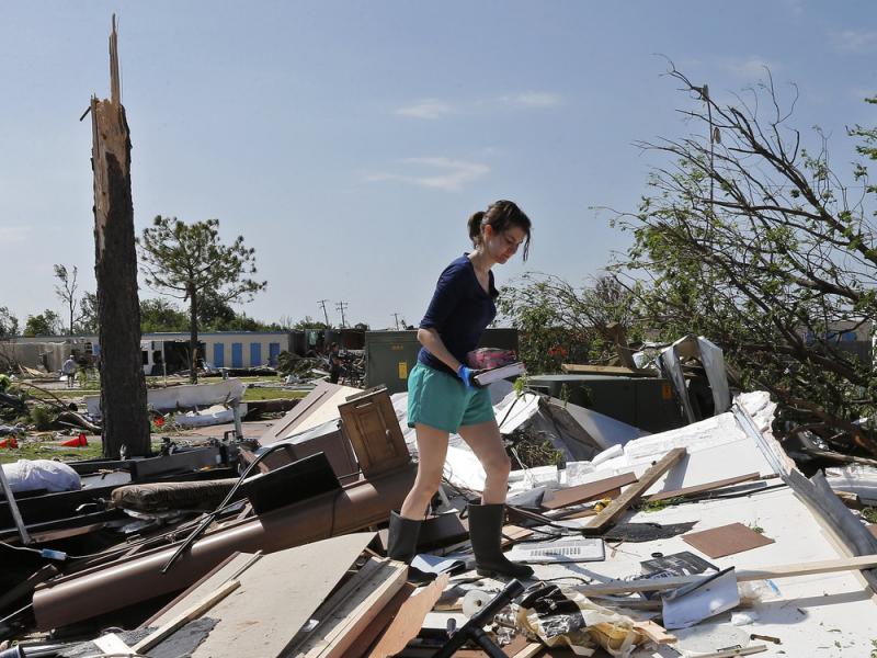 A photo from Thursday shows Dillan Taylor salvaging items from her destroyed recreational vehicle in Oklahoma City following a tornado there. More tornadoes hit the Plains states over the weekend. A photo from Thursday shows Dillan Taylor salvaging items from her destroyed recreational vehicle in Oklahoma City following a tornado there. More tornadoes hit the Plains states over the weekend.