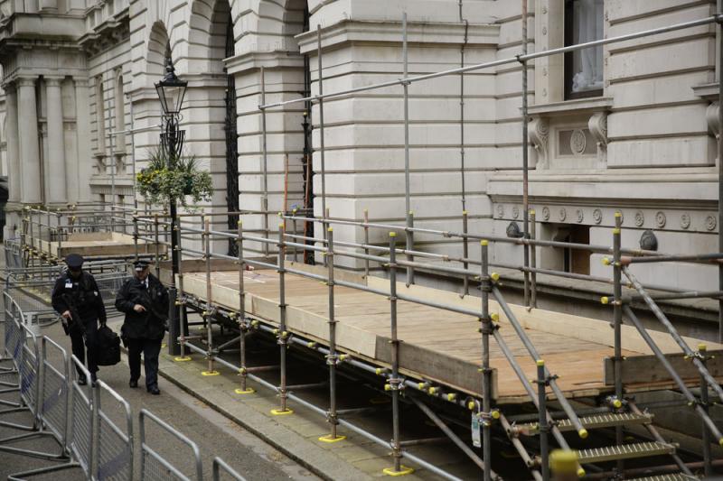 British police officers walk past newly erected media stands for the general election in Downing Street, London, on Tuesday. Britain goes to the polls on Thursday. British police officers walk past newly erected media stands for the general election in Downing Street, London, on Tuesday. Britain goes to the polls on Thursday.