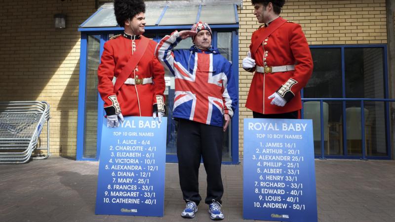 Royal supporter John Loughrey salutes with men dressed as soldiers carrying boards with proposed baby names outside the Lindo Wing of St Mary's Hospital in London on Friday. Royal supporter John Loughrey salutes with men dressed as soldiers carrying boards with proposed baby names outside the Lindo Wing of St Mary's Hospital in London on Friday.