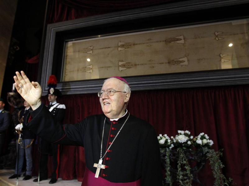 Archbishop Cesare Nosiglia presents the Holy Shroud during a preview for the news media at the Cathedral of Turin, Italy, on Saturday. The shroud â believed by many to be the burial cloth of Christ â will go on display for the first time in five Archbishop Cesare Nosiglia presents the Holy Shroud during a preview for the news media at the Cathedral of Turin, Italy, on Saturday. The shroud â believed by many to be the burial cloth of Christ â will go on display for the first time in five