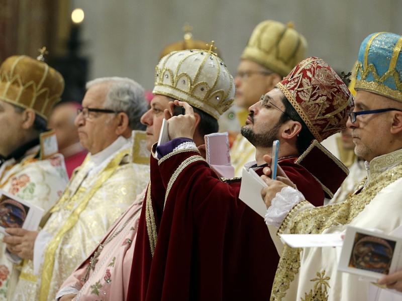 Prelates take pictures as Pope Francis celebrates an Armenian-Rite Mass to commemorate the 100th anniversary of the Armenian Genocide, in St. Peter's Basilica, at the Vatican Sunday. Prelates take pictures as Pope Francis celebrates an Armenian-Rite Mass to commemorate the 100th anniversary of the Armenian Genocide, in St. Peter's Basilica, at the Vatican Sunday.