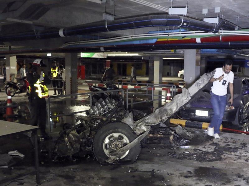 Thai officers examine the wreckage of a pickup truck after an explosion at Samui Island in Surat Thani province, Thailand. Thai officers examine the wreckage of a pickup truck after an explosion at Samui Island in Surat Thani province, Thailand.