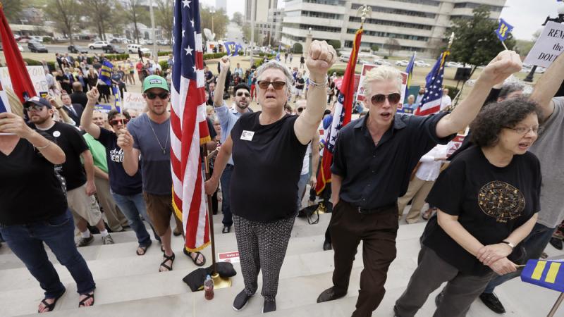 Opponents of an Arkansas religious objection measure chant outside the Arkansas state Capitol on Wednesday. Opponents of an Arkansas religious objection measure chant outside the Arkansas state Capitol on Wednesday.