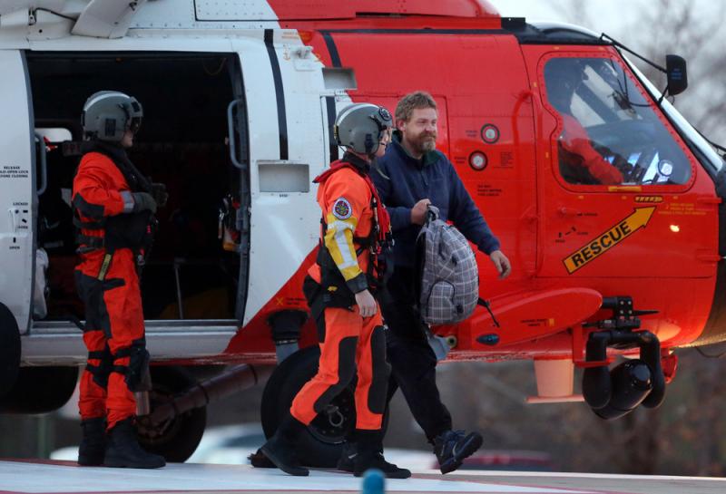 Louis Jordan (right), walks from the Coast Guard helicopter to the Sentara Norfolk General Hospital in Norfolk, Va., after being found off the North Carolina coast, on Thursday. His family says he sailed out of a marina in Conway, S.C., on Jan. 23, and ha Louis Jordan (right), walks from the Coast Guard helicopter to the Sentara Norfolk General Hospital in Norfolk, Va., after being found off the North Carolina coast, on Thursday. His family says he sailed out of a marina in Conway, S.C., on Jan. 23, and ha