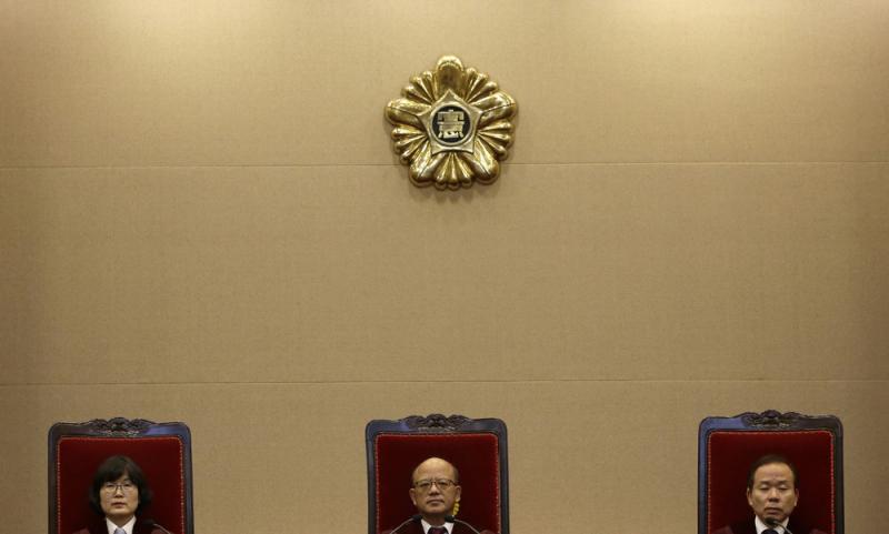 Park Han-chul (center) president of South Korea's Constitutional Court, sits with other judges prior to the ruling on the country's adultery law Thursday in Seoul. Park Han-chul (center) president of South Korea's Constitutional Court, sits with other judges prior to the ruling on the country's adultery law Thursday in Seoul.