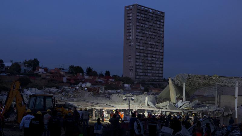 Rescue workers and police stand around the scene Thursday night as the search for survivors continues among the wreckage of a maternity and children's hospital in Cuajimalpa on the outskirts of Mexico City. Rescue workers and police stand around the scene Thursday night as the search for survivors continues among the wreckage of a maternity and children's hospital in Cuajimalpa on the outskirts of Mexico City.