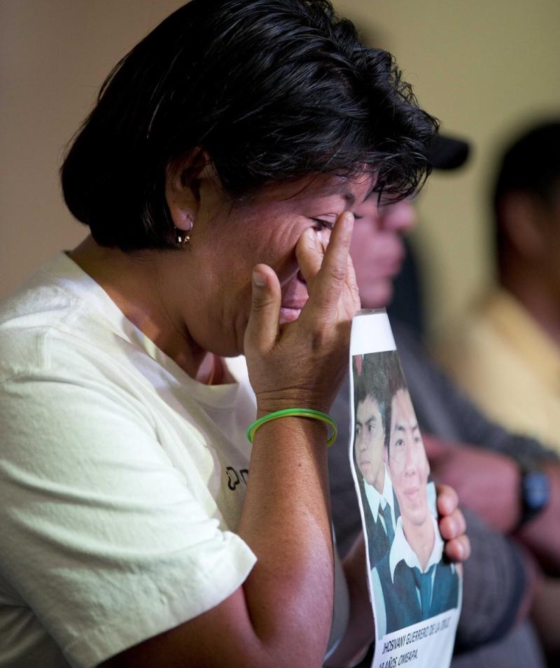 A relative holding a picture of one of the missing students, wipes a tear from her face during a press conference in Mexico, City. A relative holding a picture of one of the missing students, wipes a tear from her face during a press conference in Mexico, City.