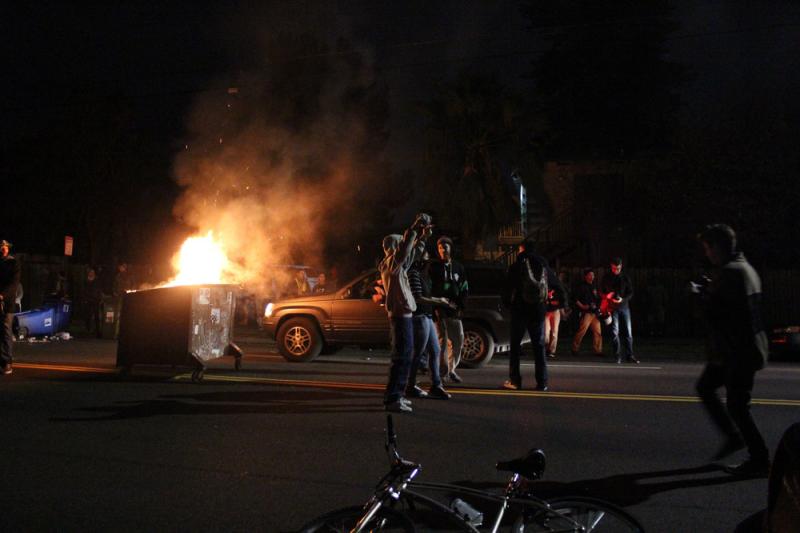 Protesters light a dumpster on fire, early Monday in Berkeley, Calif., as raucous demonstrations hit the streets of California for a second straight night in response to police killings in Missouri and New York. Protesters light a dumpster on fire, early Monday in Berkeley, Calif., as raucous demonstrations hit the streets of California for a second straight night in response to police killings in Missouri and New York.