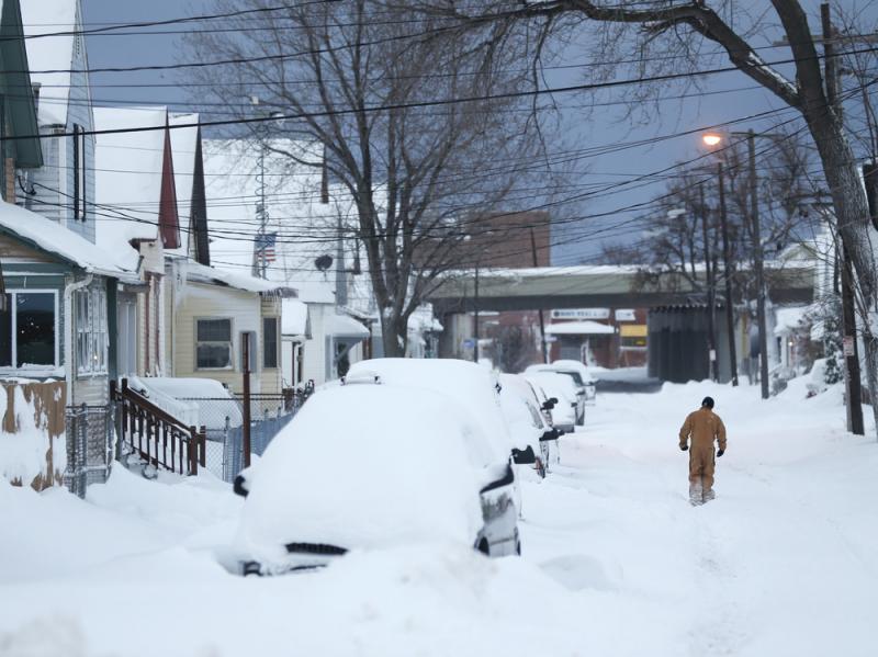 A man walks along a snow-covered street Thursday. Some areas of northern and western New York state could get a combined total of 8 feet of snow this week. A man walks along a snow-covered street Thursday. Some areas of northern and western New York state could get a combined total of 8 feet of snow this week.