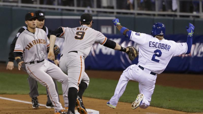 The San Francisco Giants' Brandon Belt can't reach the Kansas City Royals' Alcides Escobar as he slides safely to first base on an infield single Tuesday night during the second inning of Game 6 of baseball's World Series in Kansas City, Mo. Escobar event The San Francisco Giants' Brandon Belt can't reach the Kansas City Royals' Alcides Escobar as he slides safely to first base on an infield single Tuesday night during the second inning of Game 6 of baseball's World Series in Kansas City, Mo. Escobar event