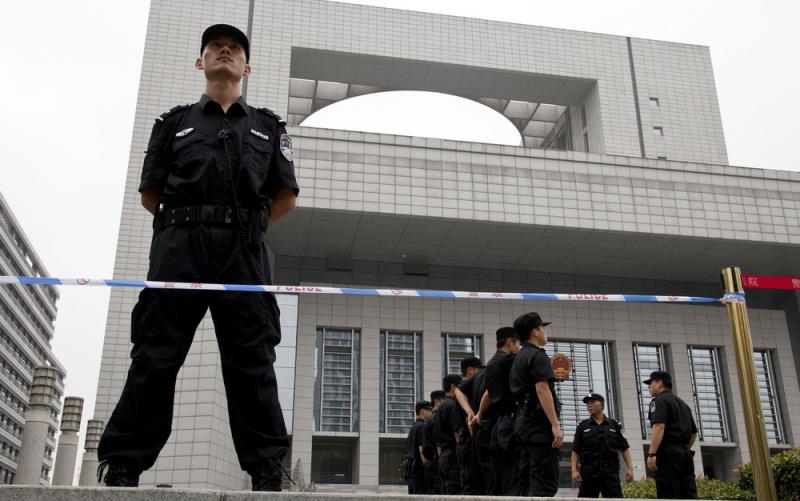 Police officers stand guard in front of the Hefei City Intermediate People's Court in China's Anhui Province. Police officers stand guard in front of the Hefei City Intermediate People's Court in China's Anhui Province.