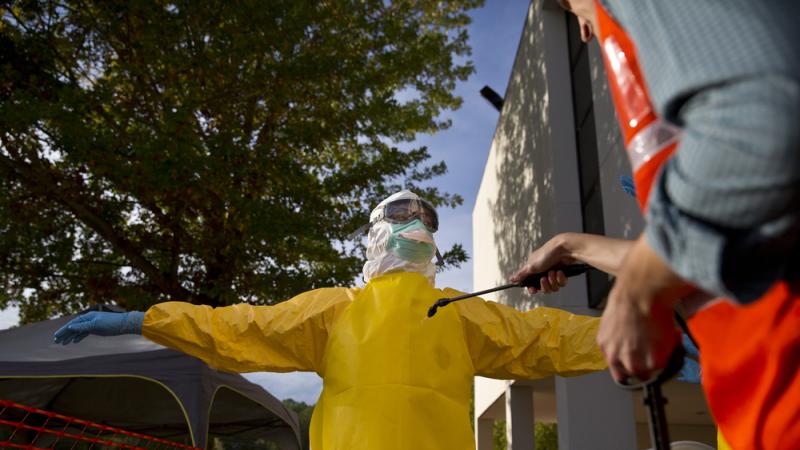 A licensed clinician is decontaminated before disrobing at the end of a simulated training session by CDC in Anniston, Ala. Training can take a several weeks, making some employers reluctant to encourage their medical workers to volunteer in the Ebola out A licensed clinician is decontaminated before disrobing at the end of a simulated training session by CDC in Anniston, Ala. Training can take a several weeks, making some employers reluctant to encourage their medical workers to volunteer in the Ebola out
