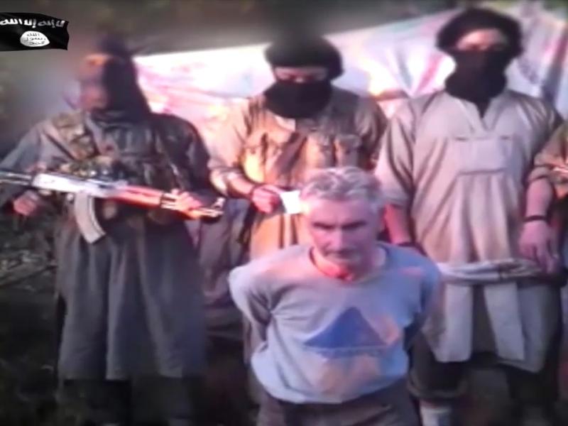This still image from video published on the Internet on Wednesday by a group calling itself Jund al-Khilafah, or Soldiers of the Caliphate, shows members of the group standing behind French mountaineer Herve Gourdel just before beheading him. This still image from video published on the Internet on Wednesday by a group calling itself Jund al-Khilafah, or Soldiers of the Caliphate, shows members of the group standing behind French mountaineer Herve Gourdel just before beheading him.