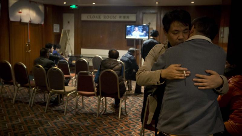Relatives of Chinese passengers aboard the missing Malaysia Airlines flight comfort each other as they wait for a news briefing by airline officials at a hotel ballroom in Beijing on Thursday. Relatives of Chinese passengers aboard the missing Malaysia Airlines flight comfort each other as they wait for a news briefing by airline officials at a hotel ballroom in Beijing on Thursday.
