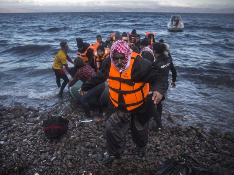 An Iraqi man disembarks from a dinghy on a beach after his trip with other refugees and migrants from the Turkish coast to the northeastern Greek island of Lesbos on Friday. An Iraqi man disembarks from a dinghy on a beach after his trip with other refugees and migrants from the Turkish coast to the northeastern Greek island of Lesbos on Friday.