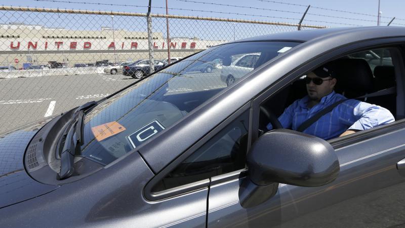 Uber driver Karim Amrani sits in his car parked near the San Francisco International Airport in July. Uber driver Karim Amrani sits in his car parked near the San Francisco International Airport in July.