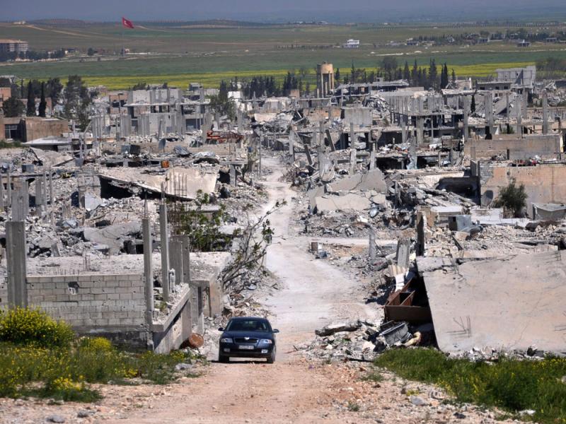 A car passes in an area that was destroyed during the battle between the U.S. backed Kurdish forces and the Islamic State fighters in Kobani, north Syria, in 2015. A car passes in an area that was destroyed during the battle between the U.S. backed Kurdish forces and the Islamic State fighters in Kobani, north Syria, in 2015.