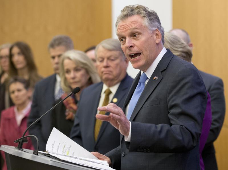 Virginia Gov. Terry McAuliffe is joined by members of the House and Senate as he announces a compromise on a set of gun bills at the Capitol in Richmond, Va., on Friday. Virginia Gov. Terry McAuliffe is joined by members of the House and Senate as he announces a compromise on a set of gun bills at the Capitol in Richmond, Va., on Friday.