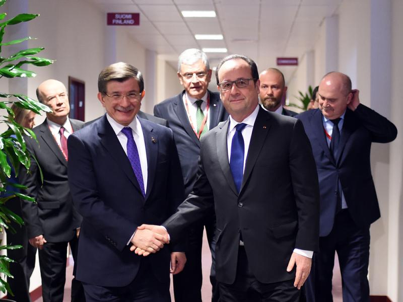 French President Francois Hollande (center right) shakes hands with Turkish Prime Minister Ahmet Davutoglu, (center left) before a meeting during an EU summit in Brussels on Friday. French President Francois Hollande (center right) shakes hands with Turkish Prime Minister Ahmet Davutoglu, (center left) before a meeting during an EU summit in Brussels on Friday.