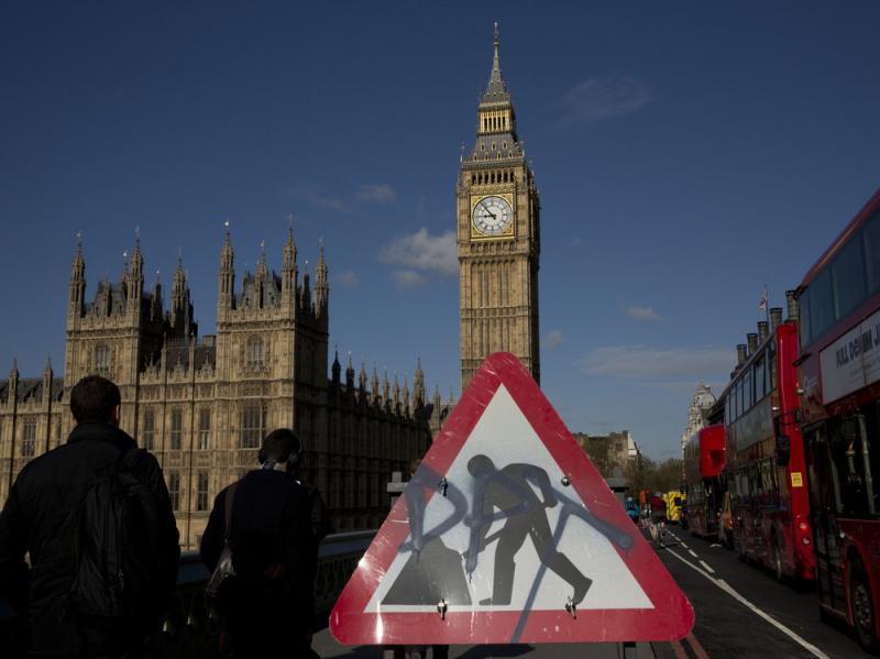 Big Ben resides in the Elizabeth Tower of the Houses of Parliament, seen in the distance behind a construction sign on Westminster Bridge. Big Ben resides in the Elizabeth Tower of the Houses of Parliament, seen in the distance behind a construction sign on Westminster Bridge.