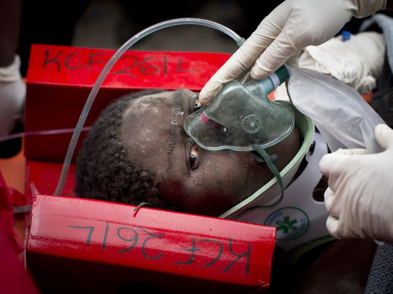 A woman is carried away in a stretcher by medics Thursday after being trapped for six days in the rubble of a collapsed building, in the Huruma area of Nairobi, Kenya. A woman is carried away in a stretcher by medics Thursday after being trapped for six days in the rubble of a collapsed building, in the Huruma area of Nairobi, Kenya.