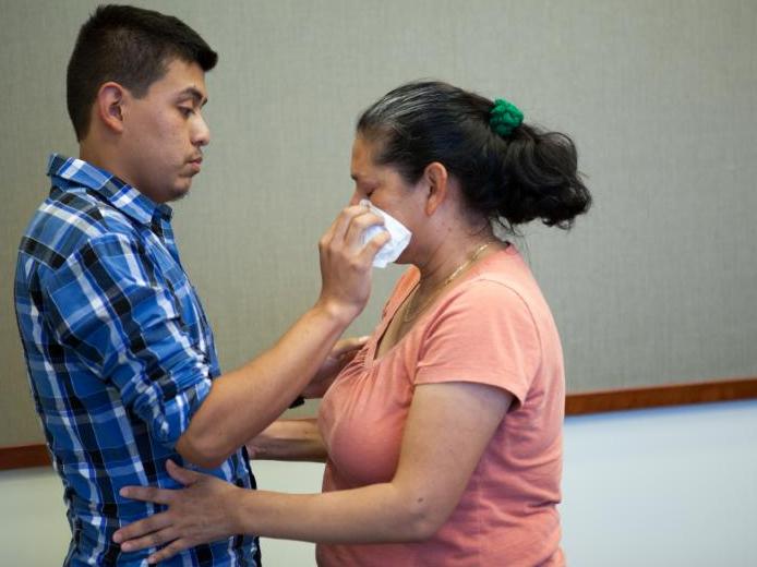 Steven Hernandez wipes a tear from his mother's eye after seeing her for the first time in 20 years in San Bernardino, Calif., on Thursday. Hernandez, 22, was abducted by his father in 1995 when he was 18 months old. Since that time, Maria Mancia, 42, had Steven Hernandez wipes a tear from his mother's eye after seeing her for the first time in 20 years in San Bernardino, Calif., on Thursday. Hernandez, 22, was abducted by his father in 1995 when he was 18 months old. Since that time, Maria Mancia, 42, had