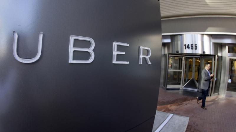 A man leaves Uber's headquarters in San Francisco. The company has been fighting a class action lawsuit brought against it by drivers for three years. A man leaves Uber's headquarters in San Francisco. The company has been fighting a class action lawsuit brought against it by drivers for three years.