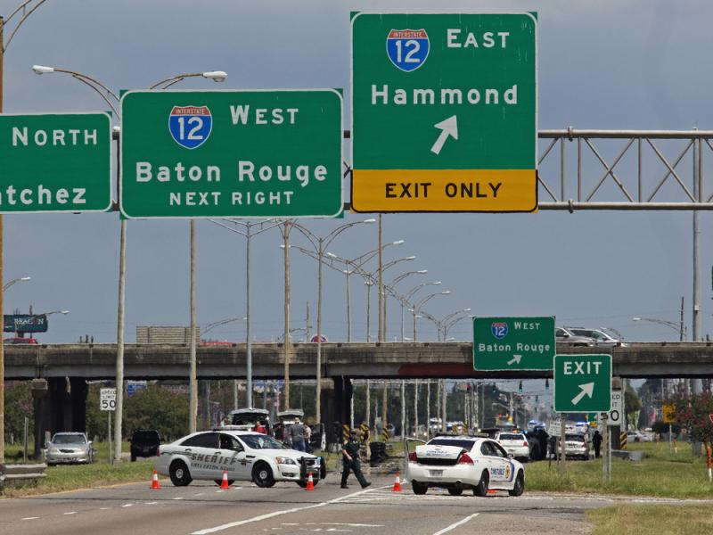 Baton Rouge police block Airline Highway after police were shot in Baton Rouge, La., Sunday, July 17, 2016. Authorities in Louisiana say several law enforcement officers are dead, and several injured in Baton Rouge after on-duty law enforcement officers w Baton Rouge police block Airline Highway after police were shot in Baton Rouge, La., Sunday, July 17, 2016. Authorities in Louisiana say several law enforcement officers are dead, and several injured in Baton Rouge after on-duty law enforcement officers w