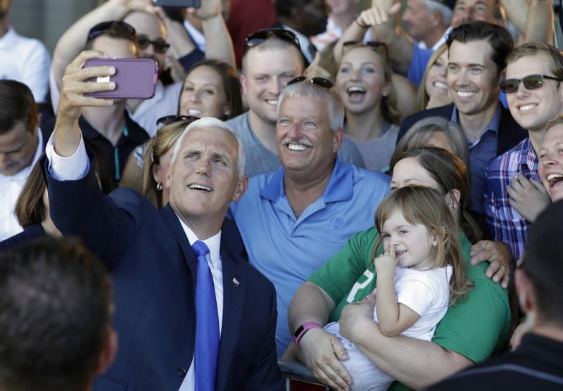 Republican vice presidential nominee Gov. Mike Pence of Indiana takes photos with supporters during a Welcome Home Rally on Saturday in Zionsville, Ind. Pence is a passionate advocate for school choice and state control over federal oversight. Republican vice presidential nominee Gov. Mike Pence of Indiana takes photos with supporters during a Welcome Home Rally on Saturday in Zionsville, Ind. Pence is a passionate advocate for school choice and state control over federal oversight.