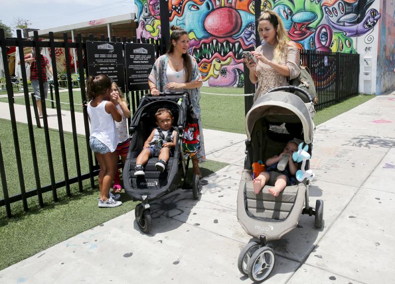 Vanessa Gomez (left) with her son Ezra, 2, and her friend Cristy Fernandez with her 9-month-old-son River, in the Wynwood neighborhood of Miami. At least 14 people likely caught Zika from mosquitoes in the neighborhood, health officials say. Gomez calls t Vanessa Gomez (left) with her son Ezra, 2, and her friend Cristy Fernandez with her 9-month-old-son River, in the Wynwood neighborhood of Miami. At least 14 people likely caught Zika from mosquitoes in the neighborhood, health officials say. Gomez calls t