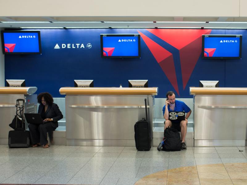 Passengers wait at Hartsfield-Jackson Atlanta International Airport after a computer systems failure on Monday caused Delta to delay or cancel hundreds of flights. Passengers wait at Hartsfield-Jackson Atlanta International Airport after a computer systems failure on Monday caused Delta to delay or cancel hundreds of flights.