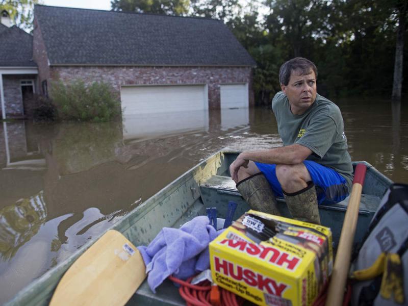 Louisiana resident David Key rides away after reviewing the damage to his home. Federal officials have expanded a disaster declaration after flooding in the state damaged tens of thousands of homes and left nine people dead. Louisiana resident David Key rides away after reviewing the damage to his home. Federal officials have expanded a disaster declaration after flooding in the state damaged tens of thousands of homes and left nine people dead.