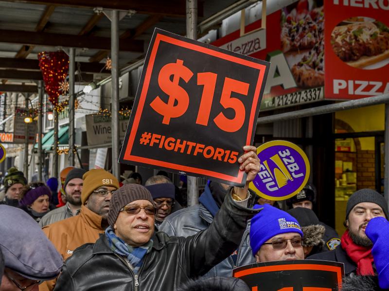 People protest for a $15 minimum wage in New York City in 2017. People protest for a $15 minimum wage in New York City in 2017.