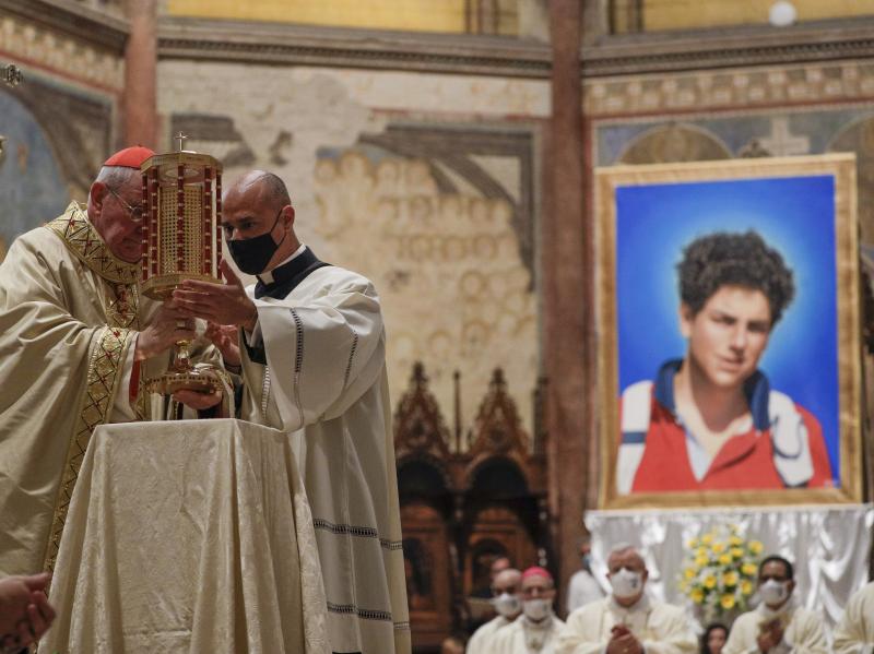 Cardinal Agostino Vallini, left, holds a relic of 15-year-old Carlo Acutis, an Italian boy who died in 2006 of leukemia, during his beatification ceremony celebrated in the St. Francis Basilica, in Assisi, Italy, on Saturday. Cardinal Agostino Vallini, left, holds a relic of 15-year-old Carlo Acutis, an Italian boy who died in 2006 of leukemia, during his beatification ceremony celebrated in the St. Francis Basilica, in Assisi, Italy, on Saturday.