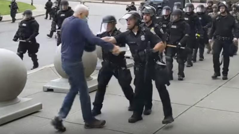 A video shows officers appearing to shove an older man who walked up to riot police Thursday in Buffalo, N.Y. Prosecutors have now filed charges against two officers. A video shows officers appearing to shove an older man who walked up to riot police Thursday in Buffalo, N.Y. Prosecutors have now filed charges against two officers.