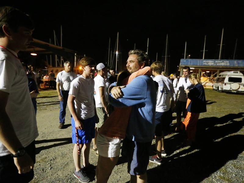 Regatta participant Robert Luiten of Mobile, Ala., right, rejoices on learning that his son, Leonard Luiten, was found after their boat capsized in a storm on Saturday, in Dauphin Island, Ala. The Coast Guard is still searching for five missing sailors. Regatta participant Robert Luiten of Mobile, Ala., right, rejoices on learning that his son, Leonard Luiten, was found after their boat capsized in a storm on Saturday, in Dauphin Island, Ala. The Coast Guard is still searching for five missing sailors.