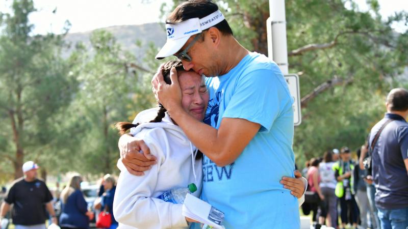 A man embraces his daughter after picking her up at Central Park in Santa Clarita, Calif., after a shooting at Saugus High School on Thursday. At least two people died in the attack, according to local law enforcement. A man embraces his daughter after picking her up at Central Park in Santa Clarita, Calif., after a shooting at Saugus High School on Thursday. At least two people died in the attack, according to local law enforcement.