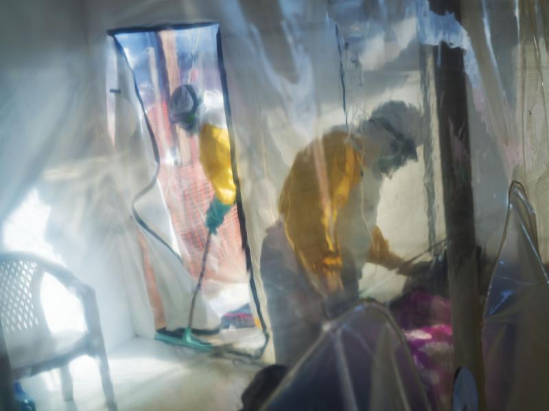 Health workers in protective suits tend to an Ebola victim kept in an isolation cube in Beni in the Democratic Republic of Congo. Health workers in protective suits tend to an Ebola victim kept in an isolation cube in Beni in the Democratic Republic of Congo.