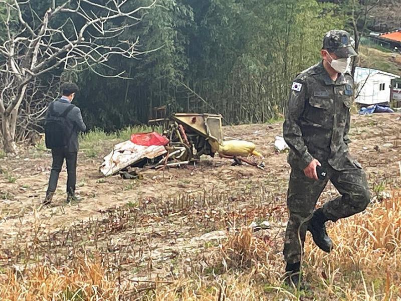 Debris from the South Korean Air force's KT-1 trainer aircraft collision are seen at a field in Sacheon, South Korea, Friday, April 1, 2022. Debris from the South Korean Air force's KT-1 trainer aircraft collision are seen at a field in Sacheon, South Korea, Friday, April 1, 2022.