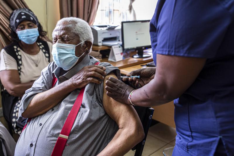 An older person receives their first dose of the AstraZeneca vaccine in Thika, Kenya. The vaccine's manufacturer, Serum Institute of India, announced this week that it will freeze all exports of the vaccine through the end of this year — leaving 20 mill An older person receives their first dose of the AstraZeneca vaccine in Thika, Kenya. The vaccine's manufacturer, Serum Institute of India, announced this week that it will freeze all exports of the vaccine through the end of this year — leaving 20 mill