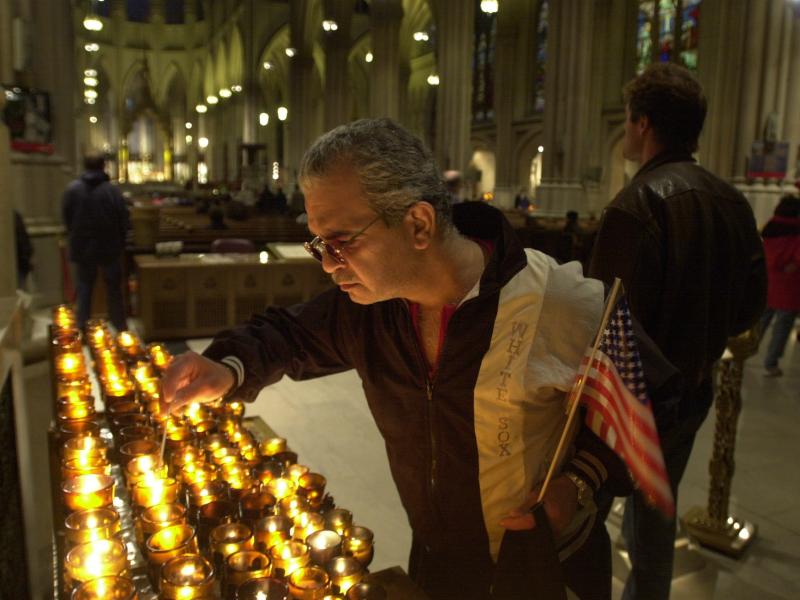A man in New York City lights a candle on Sept. 14, 2001, for the victims of the Sept. 11 terrorist attacks. A man in New York City lights a candle on Sept. 14, 2001, for the victims of the Sept. 11 terrorist attacks.