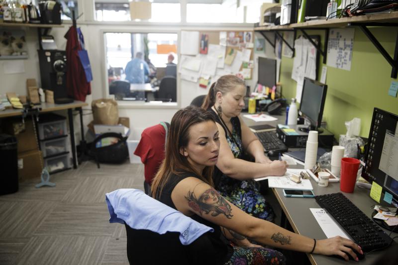 Amber Lakin (front) and colleague Julia Porras work at Central City Concern, an organization that does outreach and job training to combat homelessness and addiction in Portland, Ore. Lakin went through the welfare system and now works with Central City C Amber Lakin (front) and colleague Julia Porras work at Central City Concern, an organization that does outreach and job training to combat homelessness and addiction in Portland, Ore. Lakin went through the welfare system and now works with Central City C