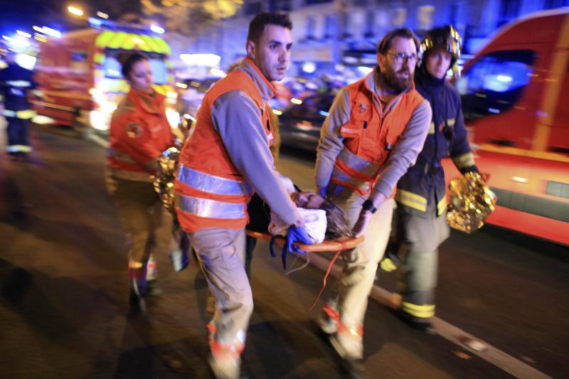 A woman is evacuated from the Bataclan concert hall in Paris after a shooting on Nov. 13, 2015. A woman is evacuated from the Bataclan concert hall in Paris after a shooting on Nov. 13, 2015.