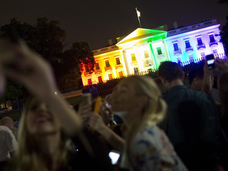 Crowds of people take photos of the White House lighted in the rainbow colors in Washington on June 26, 2015. Crowds of people take photos of the White House lighted in the rainbow colors in Washington on June 26, 2015.