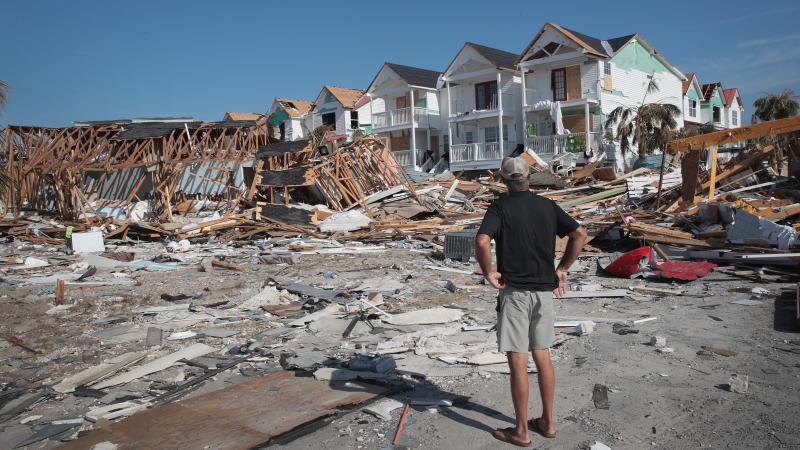 A resident of Mexico Beach, Fla., looks over damage caused to the Florida Panhandle by Hurricane Michael in October 2018. A resident of Mexico Beach, Fla., looks over damage caused to the Florida Panhandle by Hurricane Michael in October 2018.