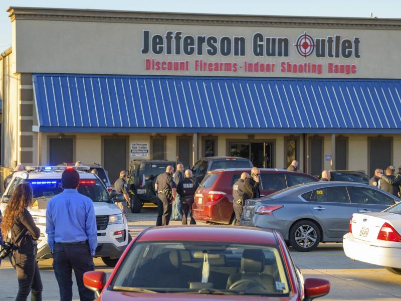 Bystanders gather at the scene of a multiple fatality shooting at the Jefferson Gun Outlet in Metairie, La., Saturday. Bystanders gather at the scene of a multiple fatality shooting at the Jefferson Gun Outlet in Metairie, La., Saturday.