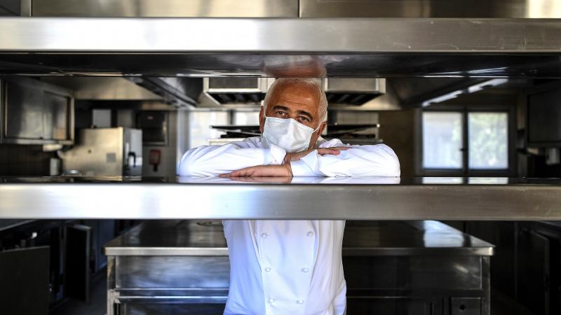 French chef Guy Savoy poses with a face mask in the kitchen of one of his restaurants, in the Monnaie de Paris building, on Tuesday. French chef Guy Savoy poses with a face mask in the kitchen of one of his restaurants, in the Monnaie de Paris building, on Tuesday.