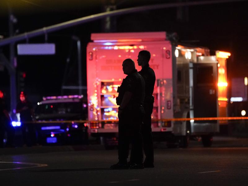 Two police officers stand outside an office building where a shooting occurred in Orange, Calif., Wednesday, March 31, 2021. The shooting killed several people, including a child, and injured another person before police shot the suspect, police said. Two police officers stand outside an office building where a shooting occurred in Orange, Calif., Wednesday, March 31, 2021. The shooting killed several people, including a child, and injured another person before police shot the suspect, police said.