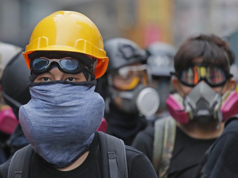 Protesters with protective gear face riot police on a Hong Kong street during the anti-extradition bill protests in August. Beijing is moving to pass a law that could outlaw such protests. Protesters with protective gear face riot police on a Hong Kong street during the anti-extradition bill protests in August. Beijing is moving to pass a law that could outlaw such protests.