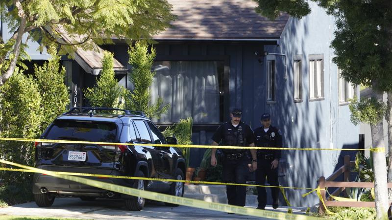 Police investigators leave a crime scene at a home in Inglewood, Calif., on Sunday. Police investigators leave a crime scene at a home in Inglewood, Calif., on Sunday.